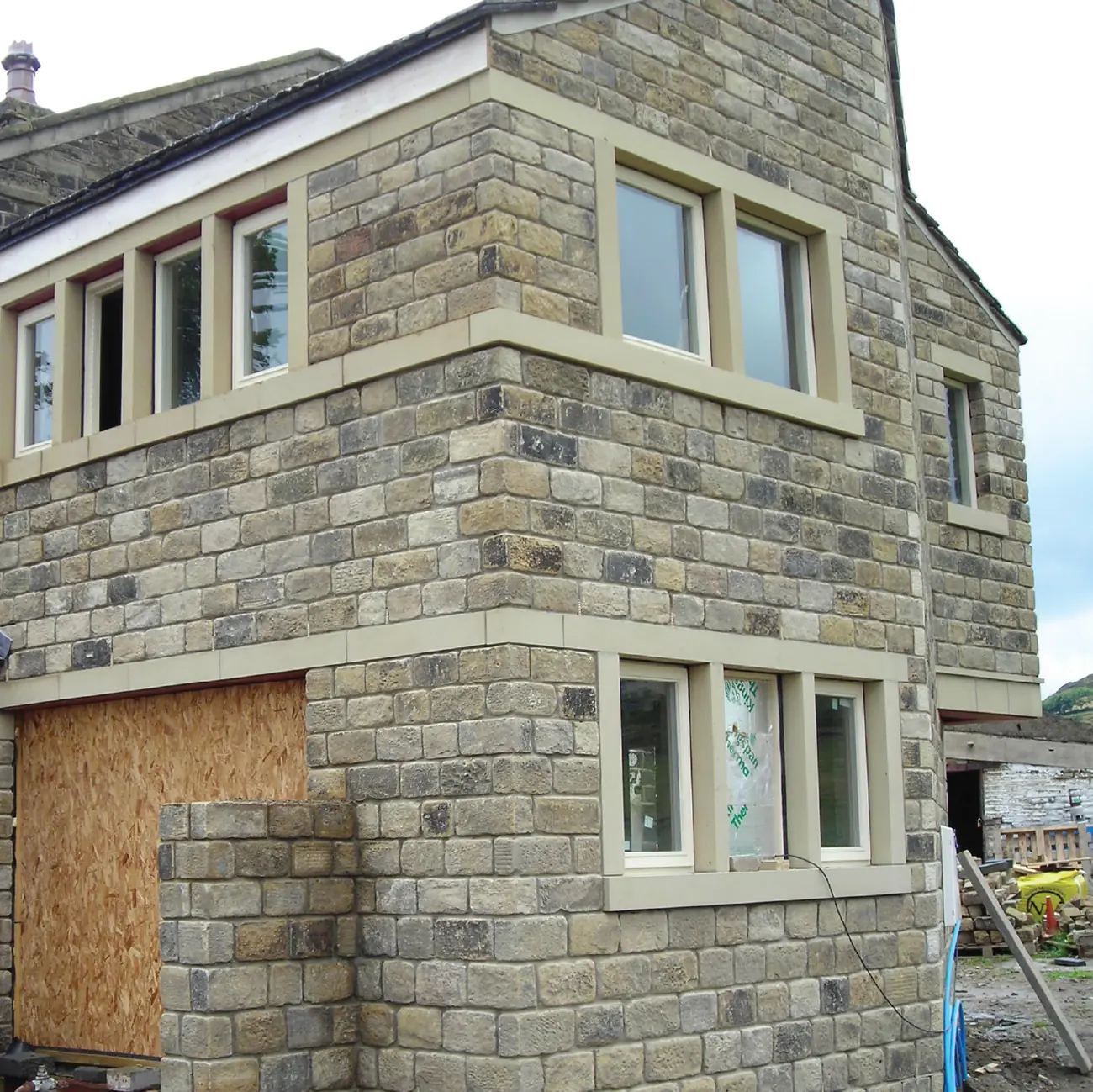 New stonework and window surrounds formed in the barn elevation