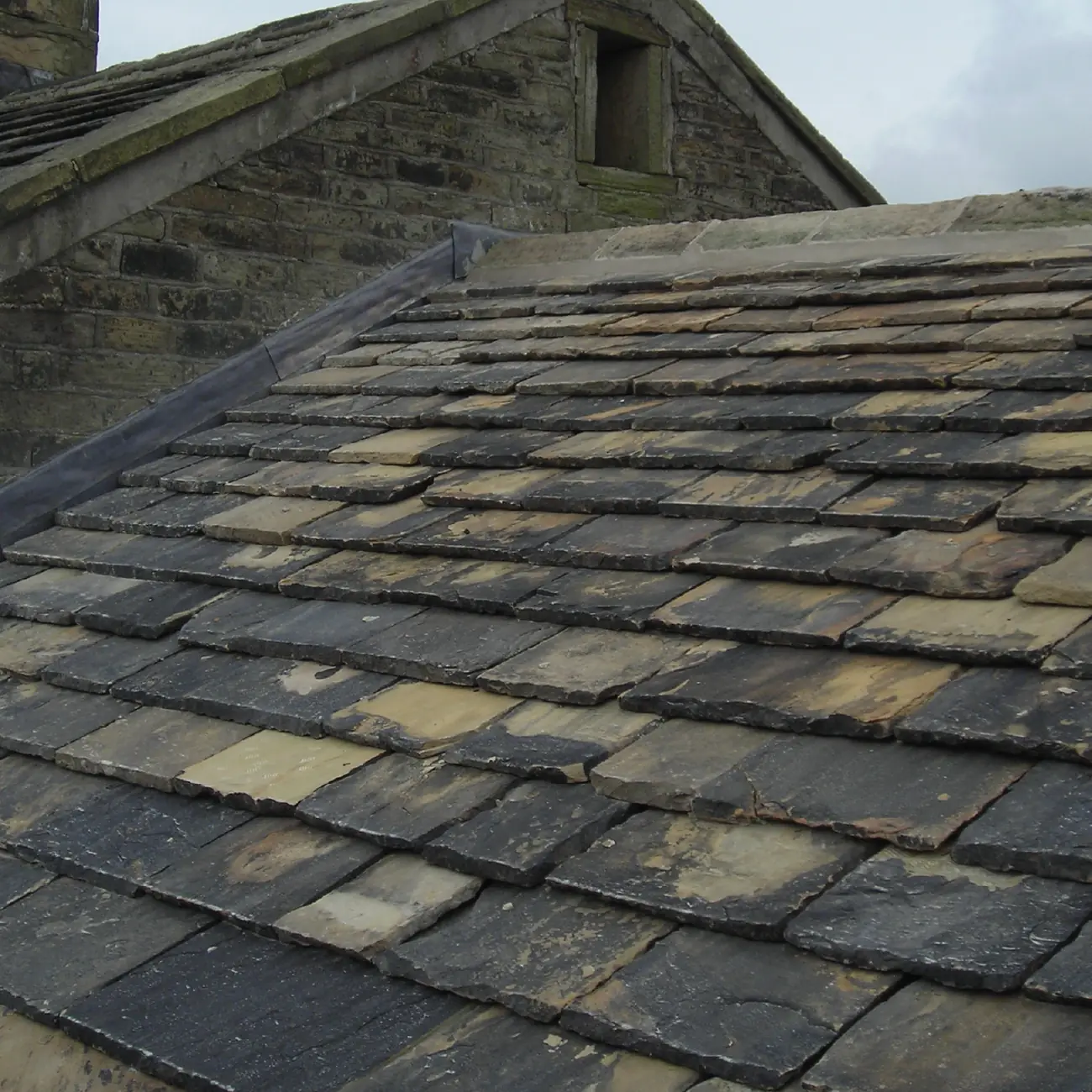 Reclaimed stone slate roof relaid over the converted barn