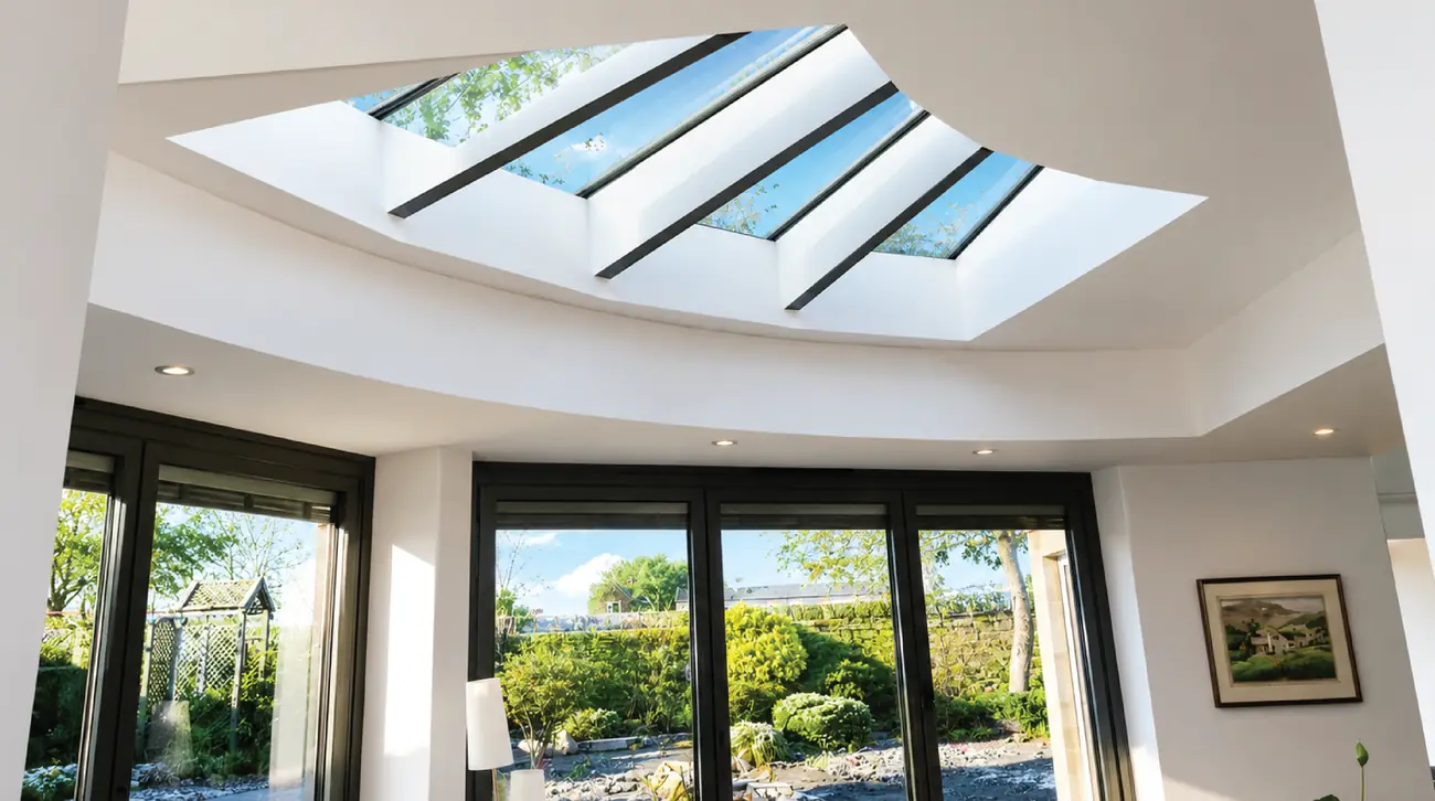 Curved interior with a faceted rooflight and full-height glazing to the garden