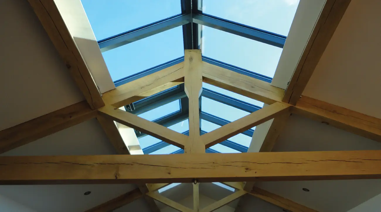 Oak trusses radiating beneath a glazed roof lantern