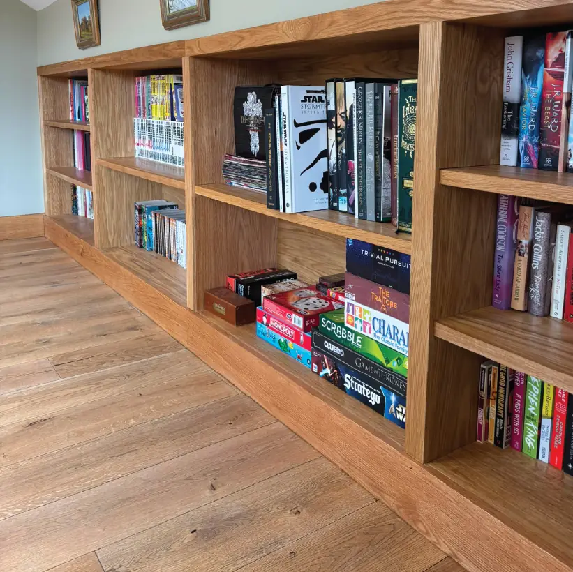 Bespoke oak bookcase with open shelving set against a wide-board oak floor