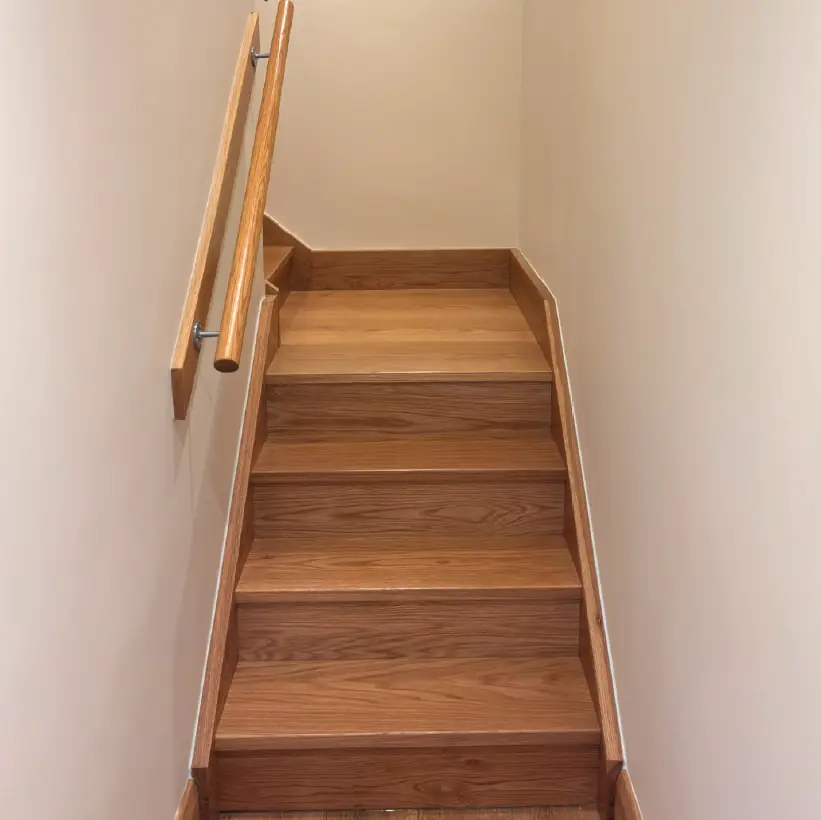 Oak straight flight staircase with a slim stainless handrail