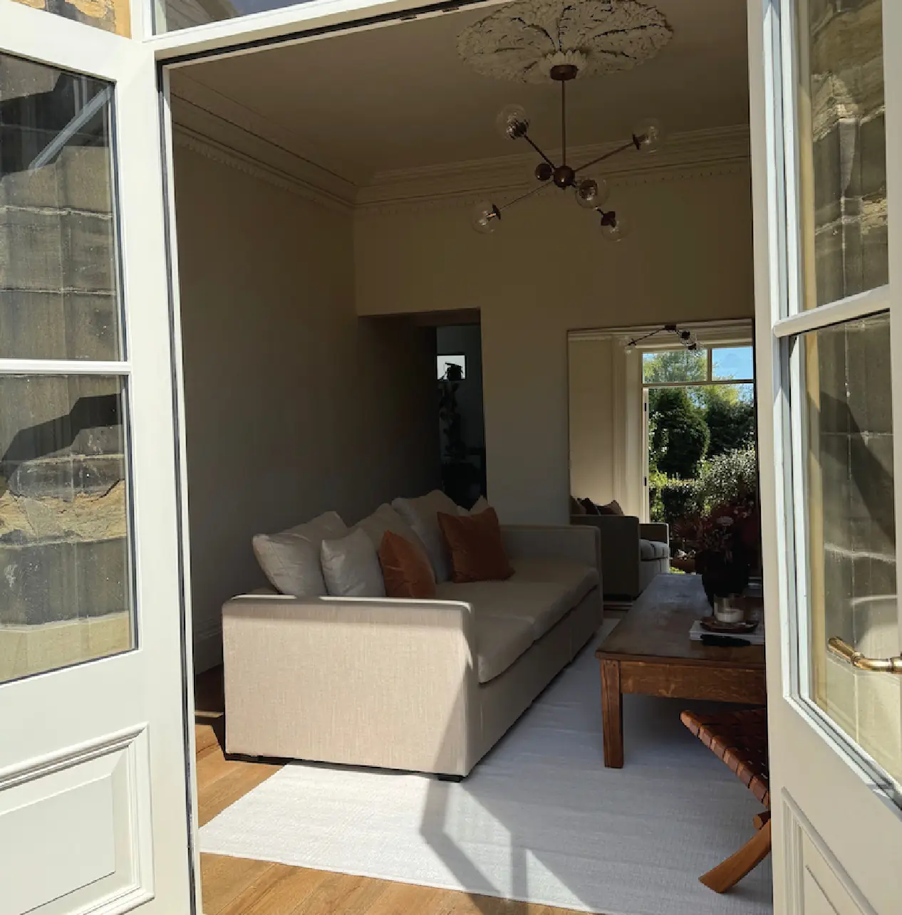 Painted glazed doors framing a view through the reception rooms